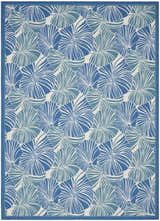 Close-up of the Waverly Sun N' Shade Blue Tropical Area Rug, featuring a light blue tropical leaf pattern.