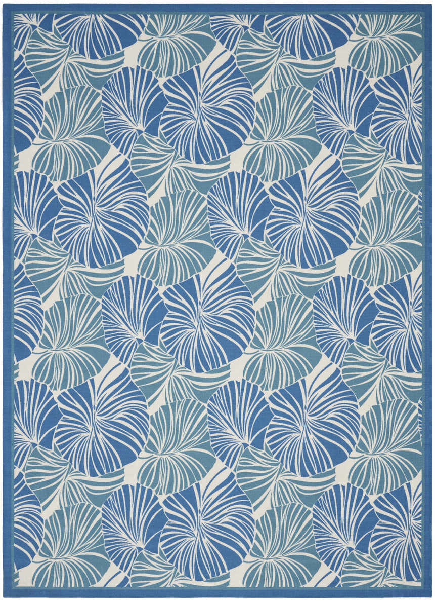 Close-up of the Waverly Sun N' Shade Blue Tropical Area Rug, featuring a light blue tropical leaf pattern.