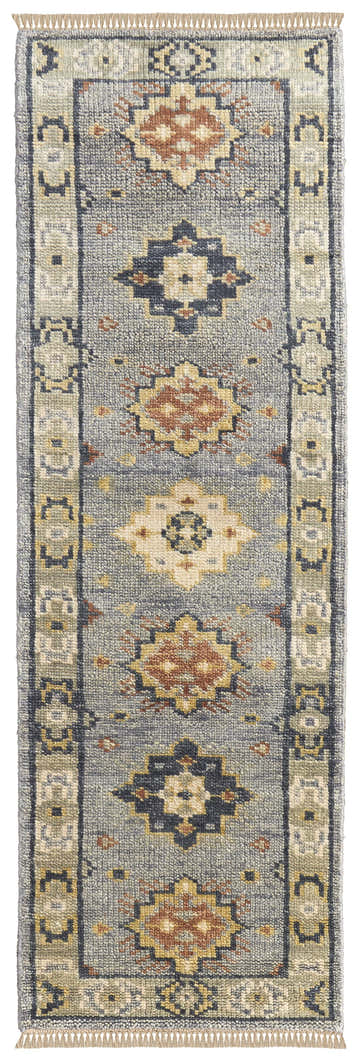 Close-up of Feizy Fillmore Transitional Diamond rug. Blue, taupe, and gray wool rug with a geometric pattern and tasseled edge. Design-Runner