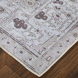 Close-up of the Feizy Percy Tan/Ivory/Gray Area Rug showing medallion pattern and neutral color palette on wood floor. Corner