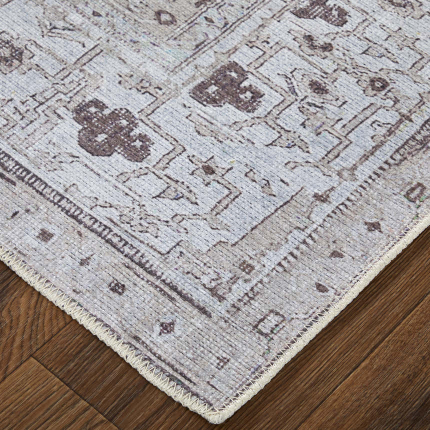 Close-up of the Feizy Percy Tan/Ivory/Gray Area Rug showing medallion pattern and neutral color palette on wood floor. Corner