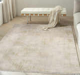 Modern living room with a Calvin Klein CK089 Drift Grey rug, white bench, and light wood floors.