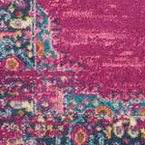 Close-up of the Nourison Passion Fuchsia rug showing its bohemian pattern, fuchsia, blue, and orange colors, and soft texture.