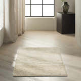 Minimalist room scene with a Calvin Klein Mesa Gypsum rug on light wood floors and neutral curtains.