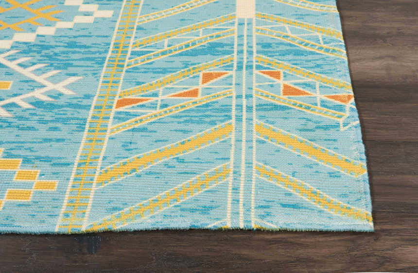 Close up of Nourison Madera Sky Blue Tribal Indoor Area Rug showing the sky blue, yellow, and white pattern.