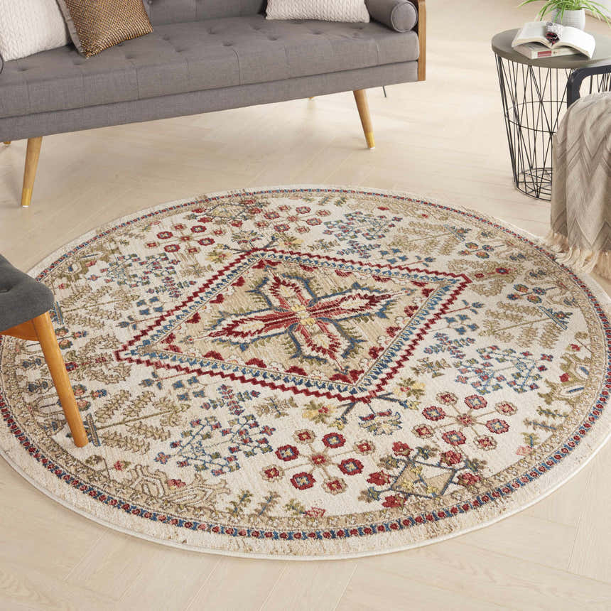 Living room scene with round Nourison Karisma Ivory rug. Farmhouse style with chestnut, red, and blue floral pattern.