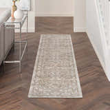 Hallway with Nourison Quarry Beige Vintage runner rug on herringbone wood floor.