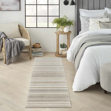 Bedroom scene with Nourison Marmara rug runner in grey, ivory, and teal stripes adding a modern touch.