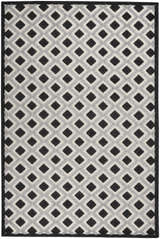 Close-up of the Nourison Aloha Black White Modern Area Rug featuring a geometric diamond pattern in black, white, and gray.