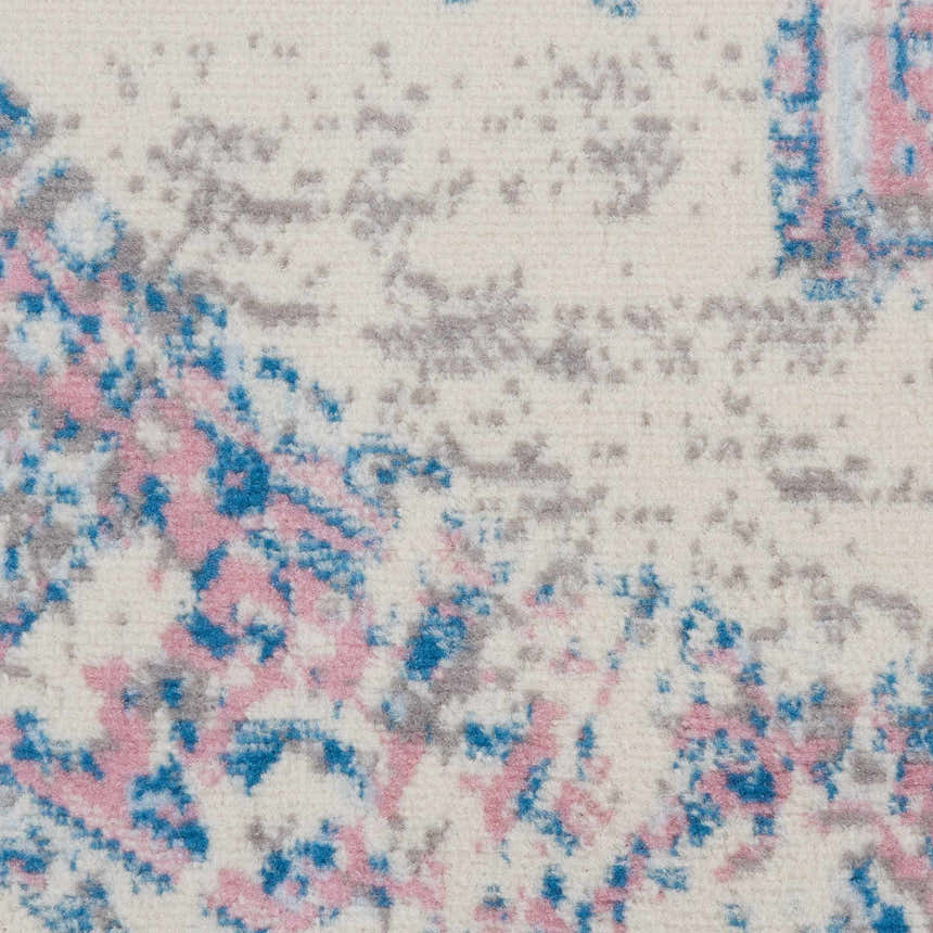 Close-up of the Nourison Grafix Ivory Pink Vintage Area Rug showing the texture and chestnut, pink and blue pattern.