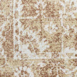 Close-up of the Nourison Astra Rust Vintage Rug. Shows texture and pattern of rust and beige on white.