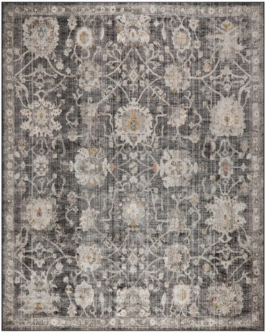 Close-up of the Nourison Oushak Home Charcoal Vintage Area Rug, featuring a floral taupe pattern on a dark gray background.