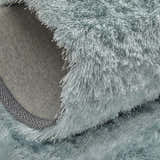 Close-up of the Feizy Indochine Modern Solid rug in blue and silver gray, showing its texture and hand-tufted construction. Fold