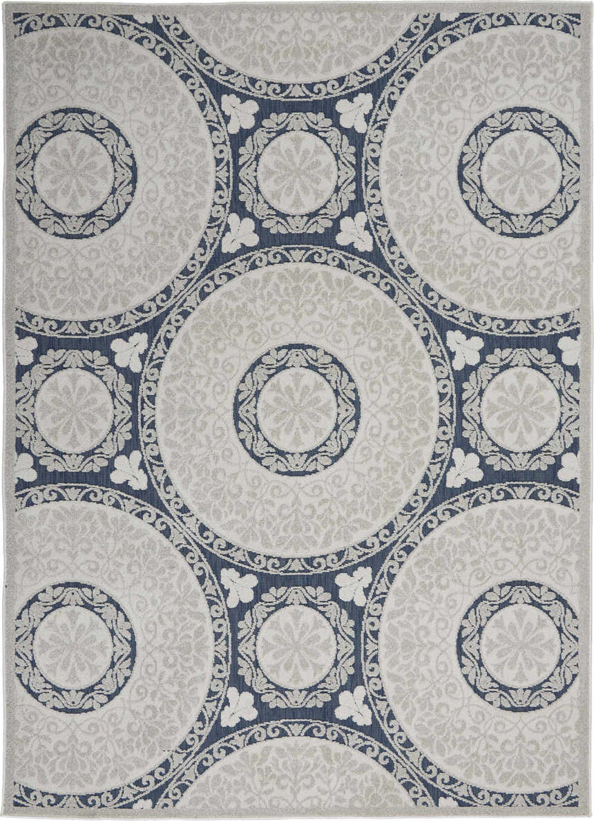 Close-up of Nourison Key Largo Blue rug. Contemporary design with blue circles and light gray floral pattern.