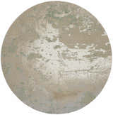Close-up of a round Nourison Twilight Ivory Green rug with a chestnut, abstract pattern and subtle texture.