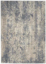 Close-up of Nourison Sahara Ivory/Slate rug. Artistic design in ivory, slate blue, and chestnut colors. Abstract pattern.