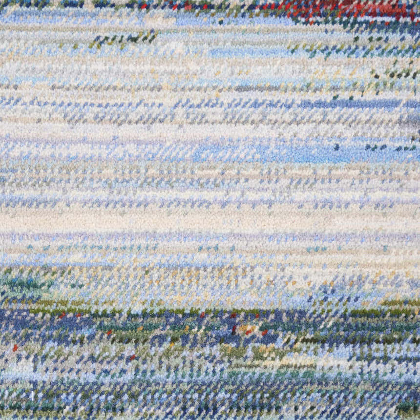 Close-up of the Nourison Chroma Crimson Tide rug, showing a textured, striated pattern in shades of crimson, blue, green, and white.