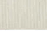 Close-up of the Calvin Klein Pretoria Ivory rug. The rug has a grid-like pattern and a soft, textured feel.