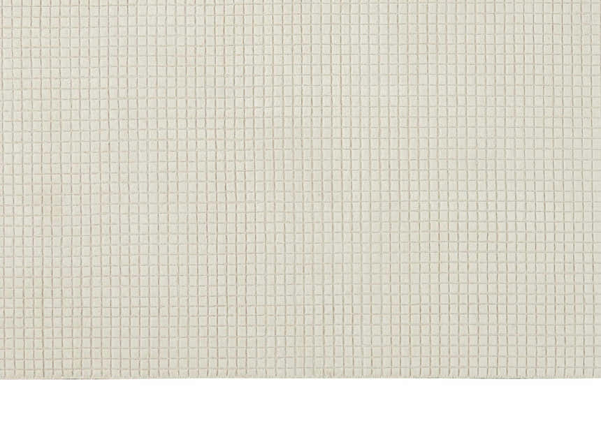 Close-up of the Calvin Klein Pretoria Ivory rug. The rug has a grid-like pattern and a soft, textured feel.