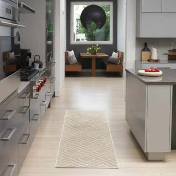 Modern kitchen with stainless steel appliances and Nourison Care Free Beige runner rug.