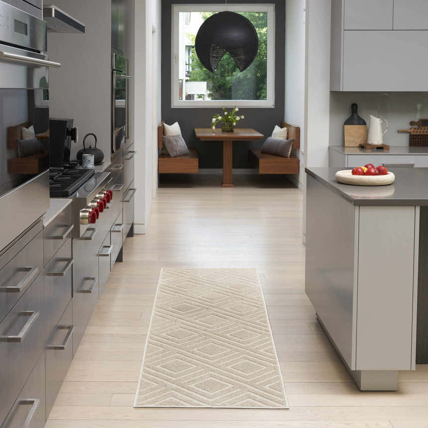 Modern kitchen with stainless steel appliances and Nourison Care Free Beige runner rug.