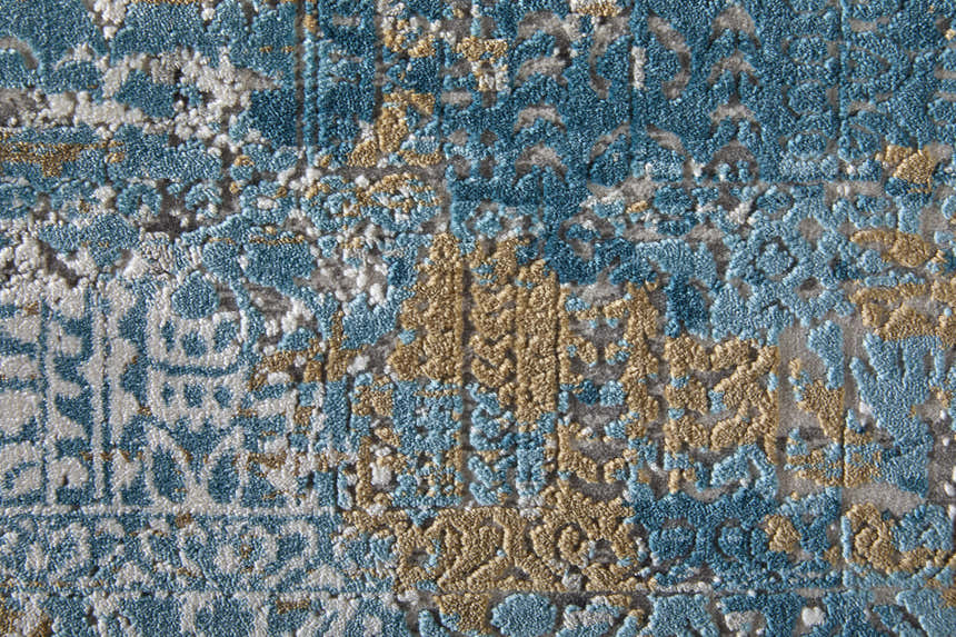 Close-up of the Feizy Cadiz rug. Abstract design in textured blue, gray, and gold acrylic, cotton, and viscose. Texture