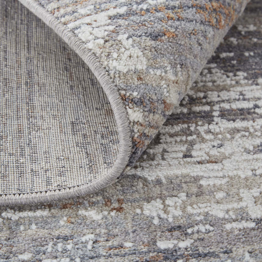 Close-up of the Feizy Lennon Taupe/Tan/Orange Area Rug showing abstract pattern and texture. Fold
