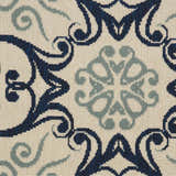 Close-up of the Nourison Caribbean Ivory Navy rug. Features a detailed floral and scroll pattern in navy and light blue.
