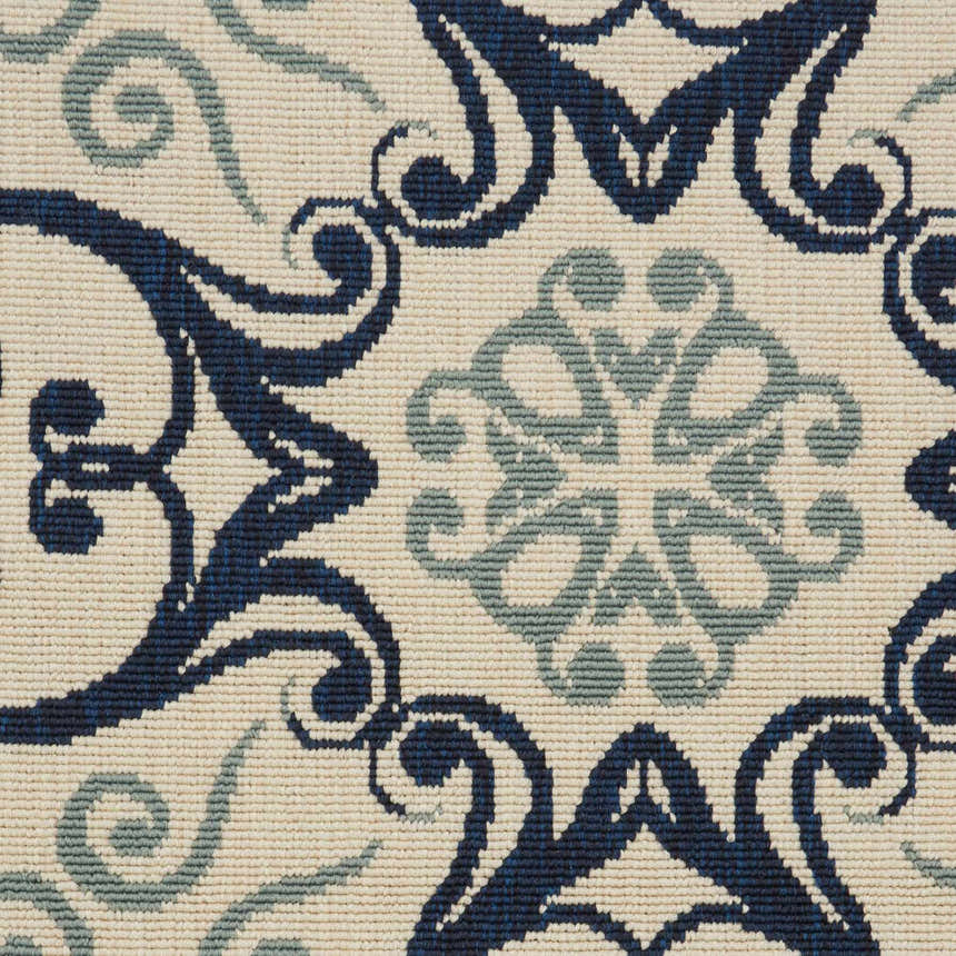 Close-up of the Nourison Caribbean Ivory Navy rug. Features a detailed floral and scroll pattern in navy and light blue.