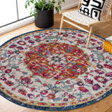 Bright Tigril Blue & Orange 2304 Area Rug in a cozy reading nook with a chair, pillow, and plant. Roomscene-Round
