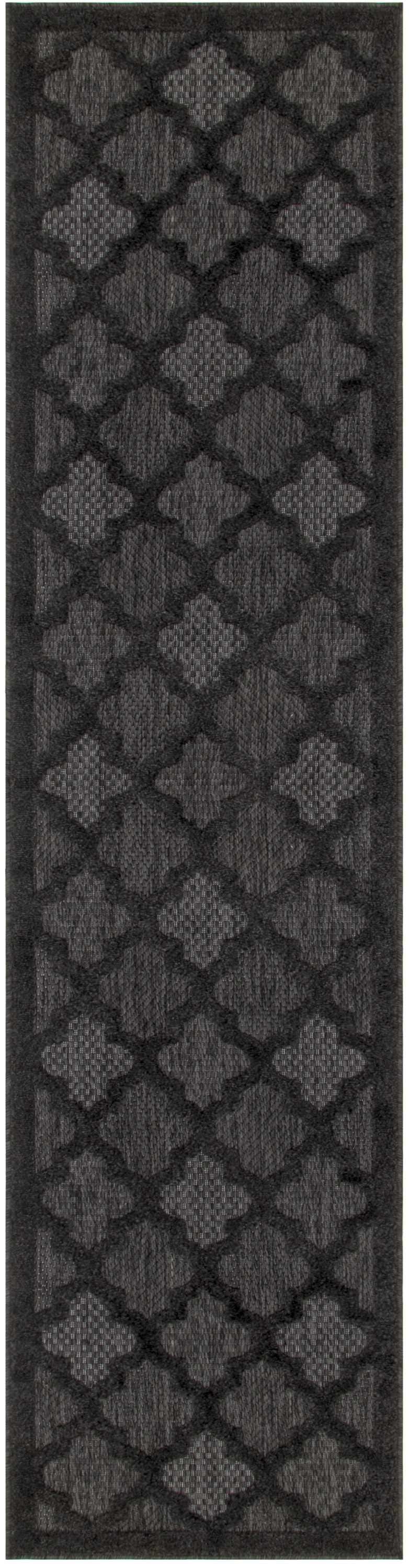 Close-up of the Nourison Easy Care Charcoal Black rug, featuring a quatrefoil trellis pattern.
