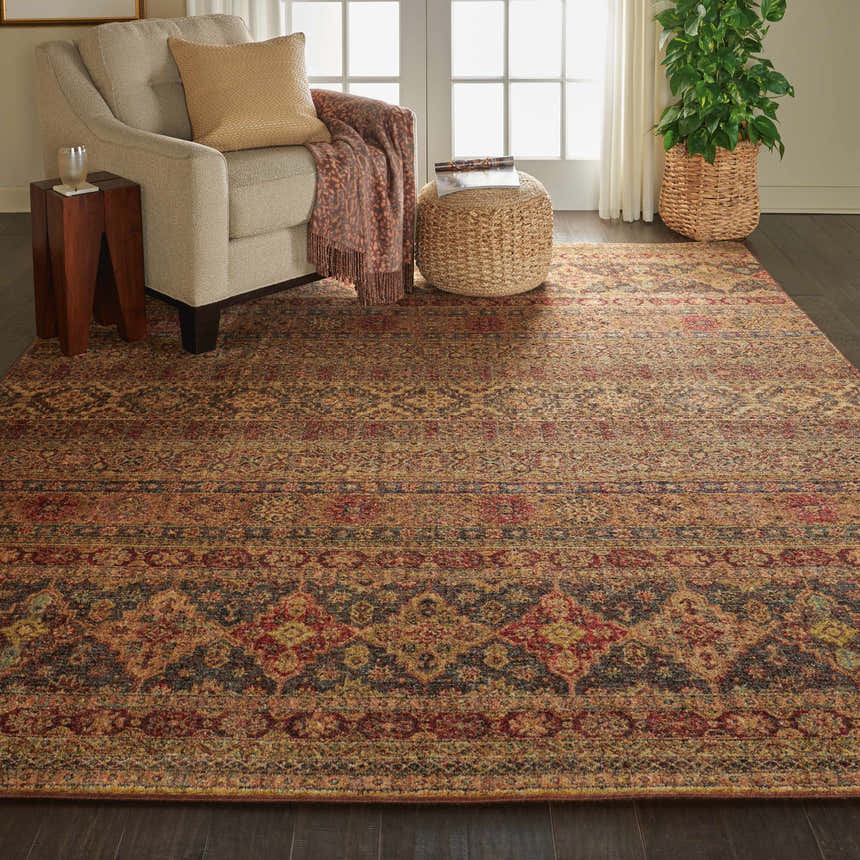 Living room scene with Nourison Jewel Blue Red Moroccan rug, beige armchair, and woven ottoman.