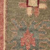 Close-up of the Nourison Tahoe Rust rug showing its wool texture and traditional floral pattern in rust, beige, and green.
