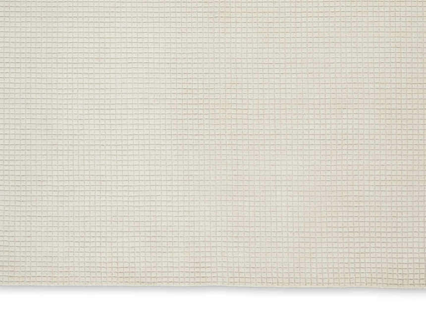 Close-up of the Calvin Klein Pretoria Ivory rug, showing its subtle grid pattern and soft mohair wool texture.