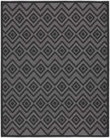 Close-up of Nourison Versatile Charcoal Black rug with taupe diamond and zigzag pattern. Mid-century modern style.
