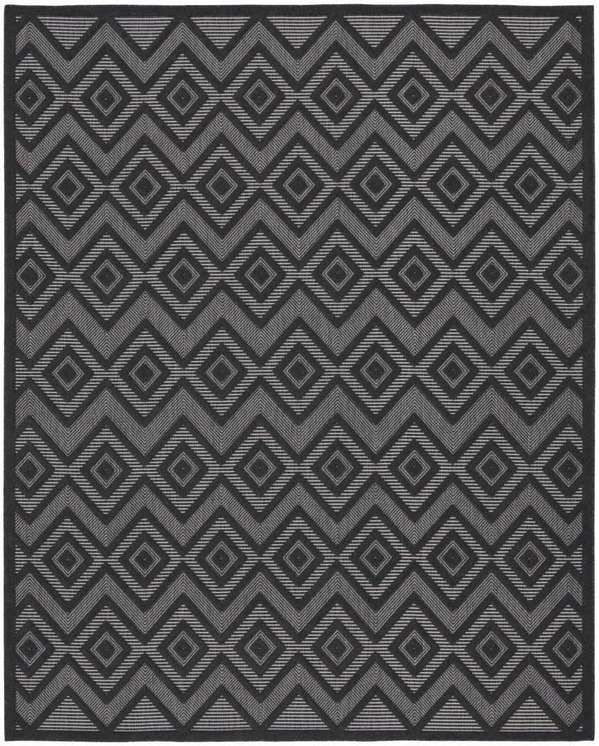 Close-up of Nourison Versatile Charcoal Black rug with taupe diamond and zigzag pattern. Mid-century modern style.