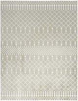 Close-up of Nourison Astra Sage Bohemian Rug. Muted sage rug with white geometric diamond and tassel pattern. Machine-made texture.