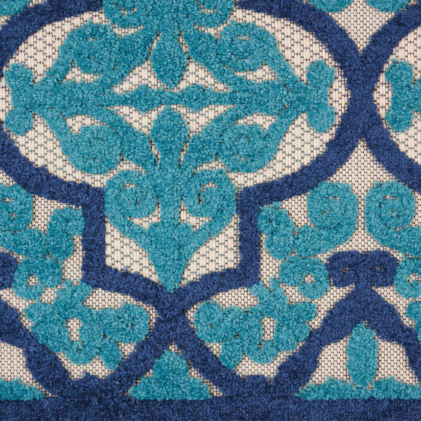 Close-up of the Nourison Aloha Navy Bohemian Area Rug, featuring a textured floral design in navy and teal.