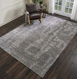 Living room scene with a brown leather chair on a Nourison Ellora Slate modern area rug.