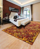Elegant bedroom with Nourison Timeless Pomegranate Persian rug, tufted headboard, and natural light.