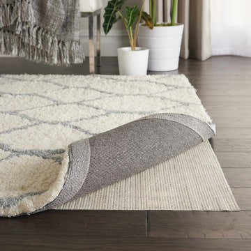 Close-up of the Nourison ShiftLoc Non-slip Pad Area Rug showing its texture and non-slip backing. Chestnut color.