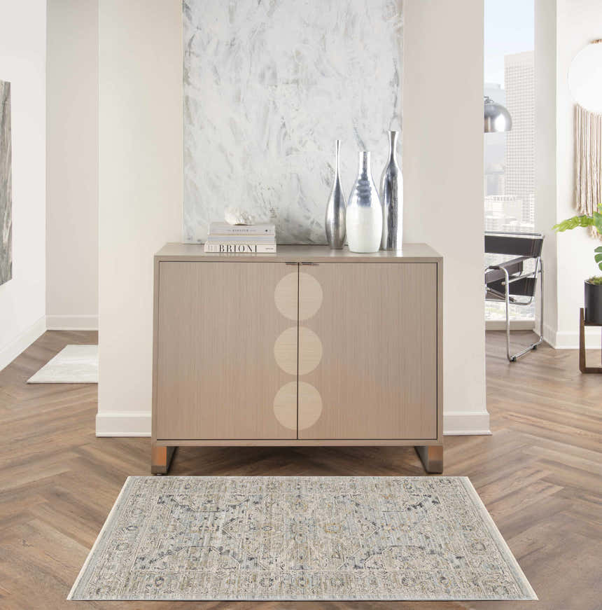Entryway with a Nourison Lynx Light Blue Vintage rug, wood floors, and a modern cabinet.