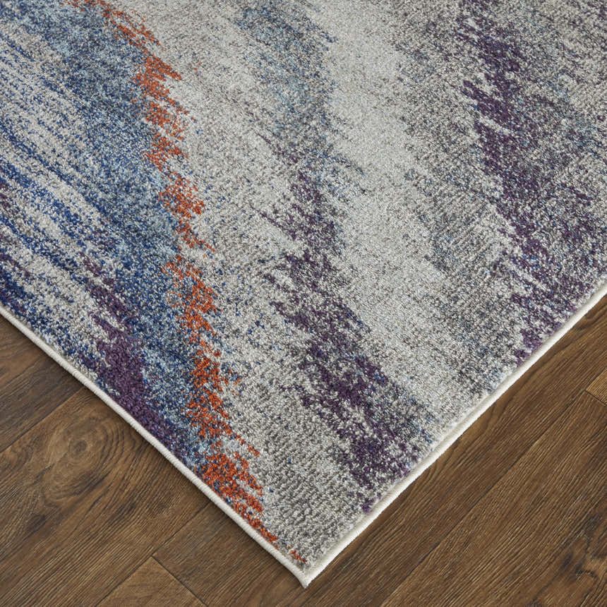 Close up of Feizy Edgemont rug. Abstract design in blue, gray, and orange hues. Casual, contemporary style. Jute, polyester, and polypropylene. Corner