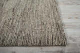 Close-up of the handmade Nourison OCEAN Sand area rug. The rug has a textured, striated design in sandstone colors.