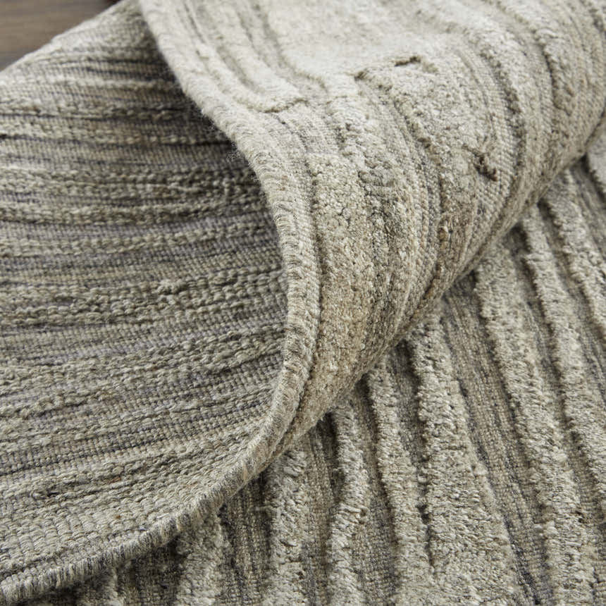 Close-up of the hand woven Feizy Braeside Taupe/Gray Area Rug showing its wool and viscose texture and abstract pattern. Fold