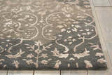 Close up of the Nourison Opaline Charcoal Vintage Area Rug showing the floral and circular taupe pattern.