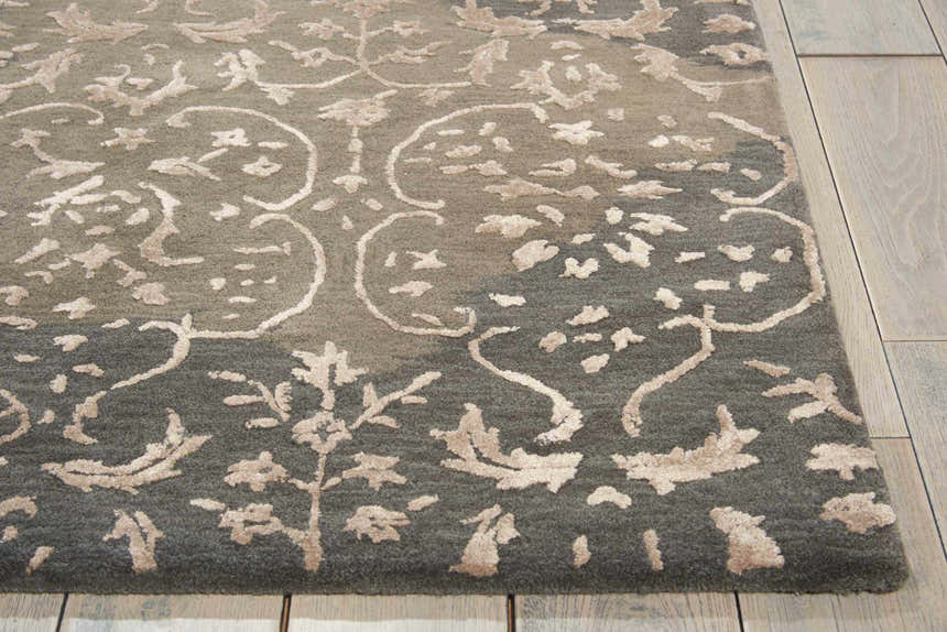 Close up of the Nourison Opaline Charcoal Vintage Area Rug showing the floral and circular taupe pattern.