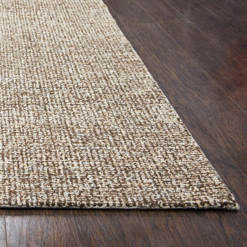 Close-up of the textured Rizzy BR360A area rug in dark red and white on dark wood flooring. 100% Wool. Corner