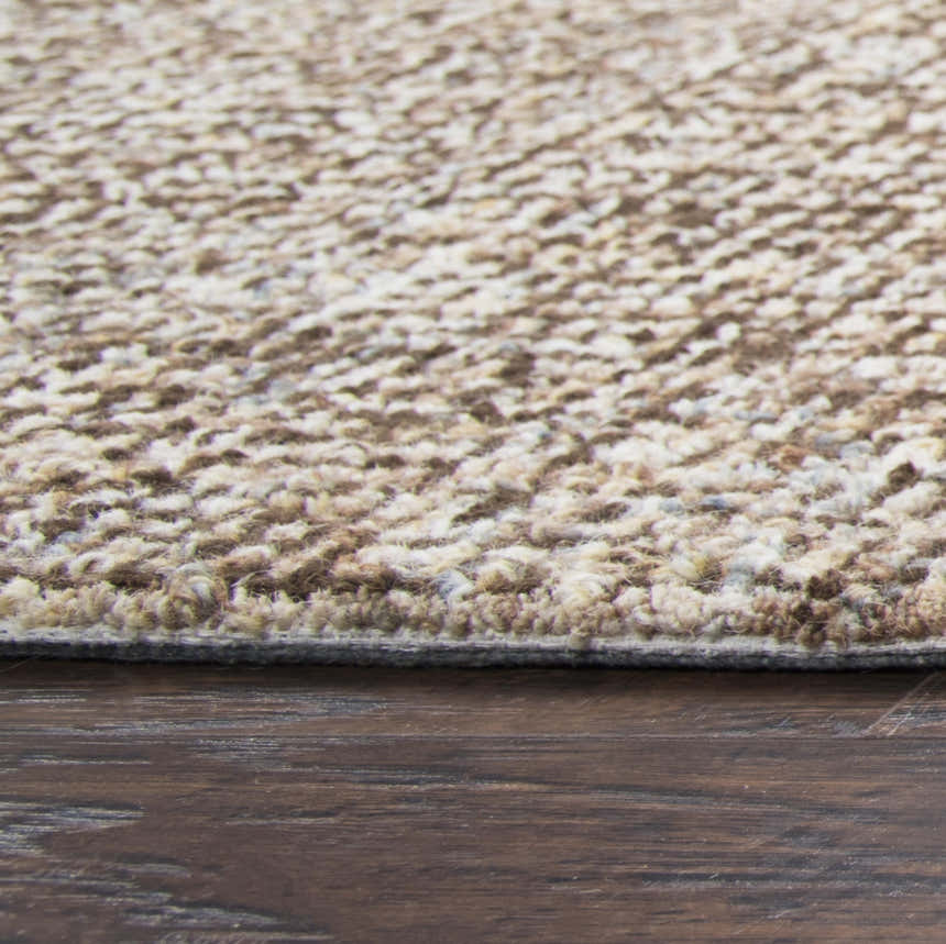 Close-up of the hand-tufted Rizzy BR360A area rug. Dark red and white wool fibers create a textured, casual design. Pile