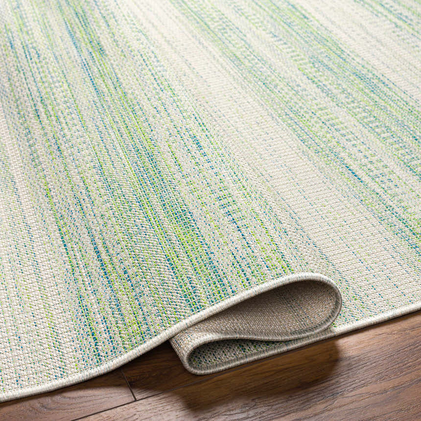 Close-up of the Kris Green Area Rug showing its woven texture and colors of dark beige, moss, and natural gray. Fold